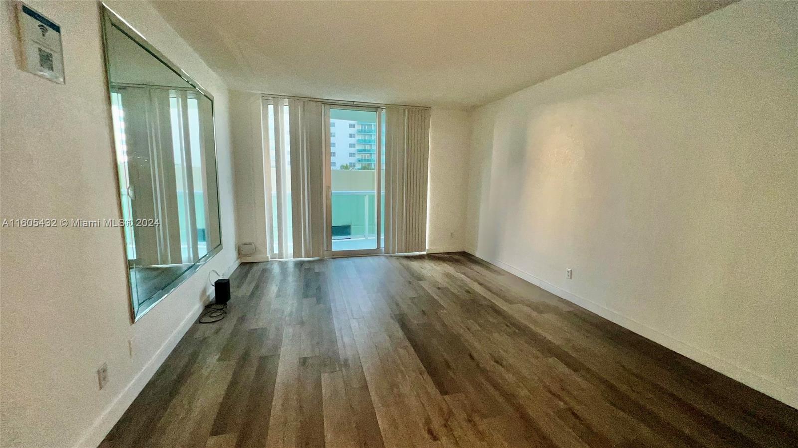 a view of a room with wooden floor and gate