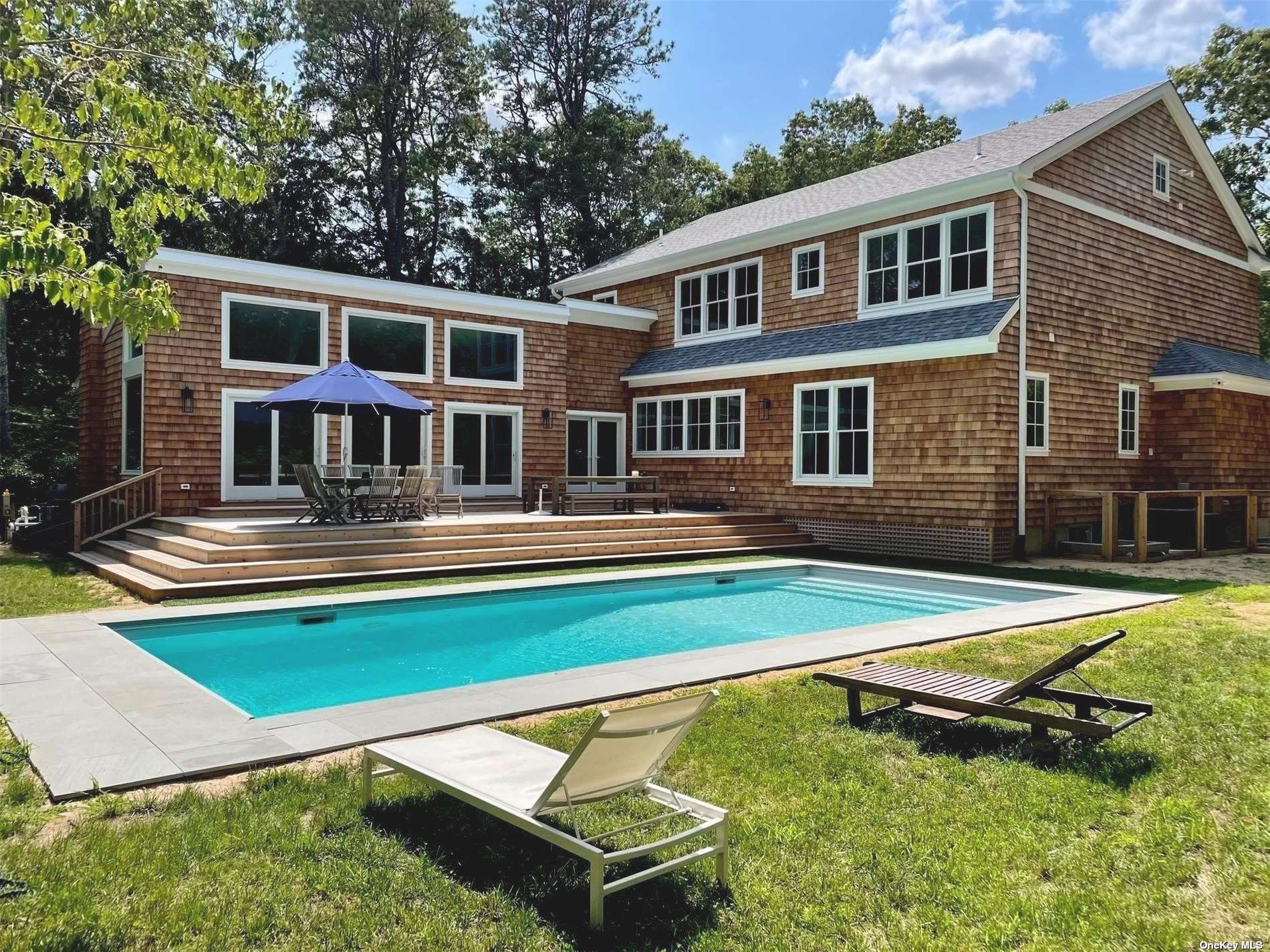 a house with swimming pool in front of it