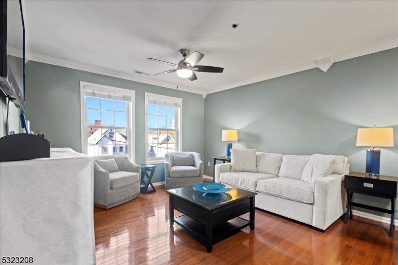 a living room with furniture and a chandelier