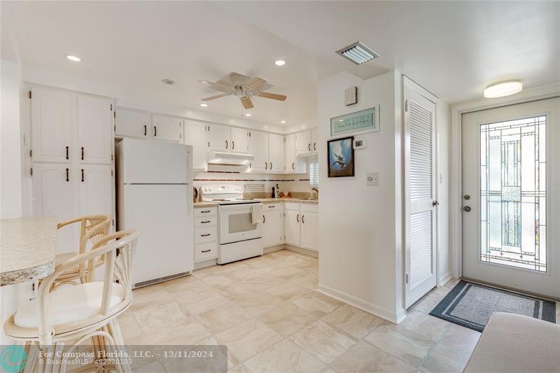 a kitchen with stainless steel appliances a refrigerator sink and cabinets