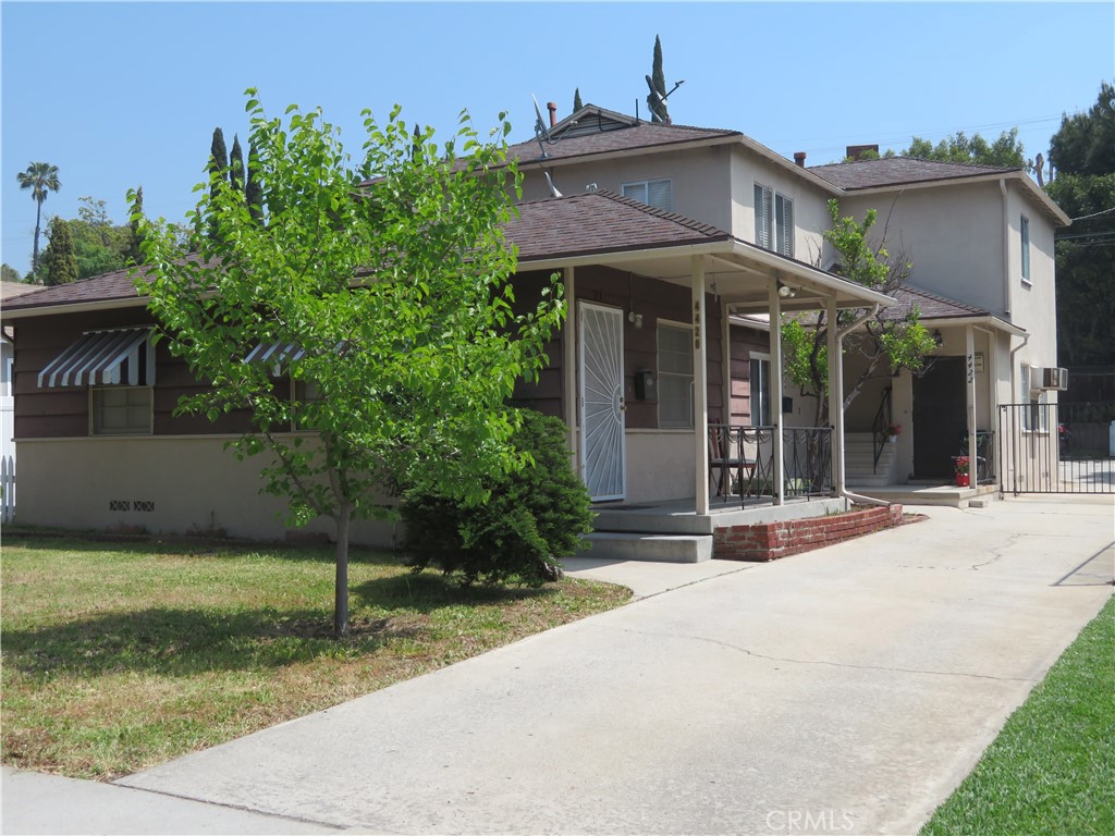 a view of a house with backyard porch and sitting area