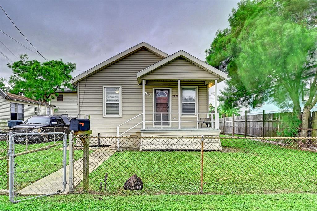 a view of a house with a yard and sitting area