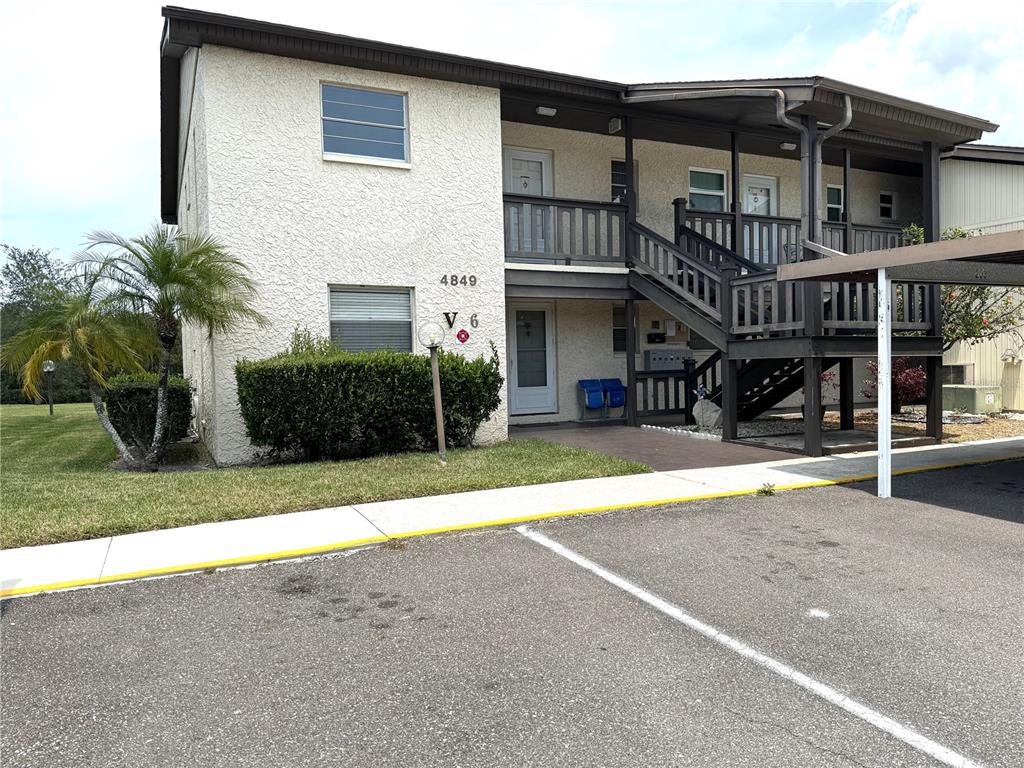 a view of a house with a patio and a yard