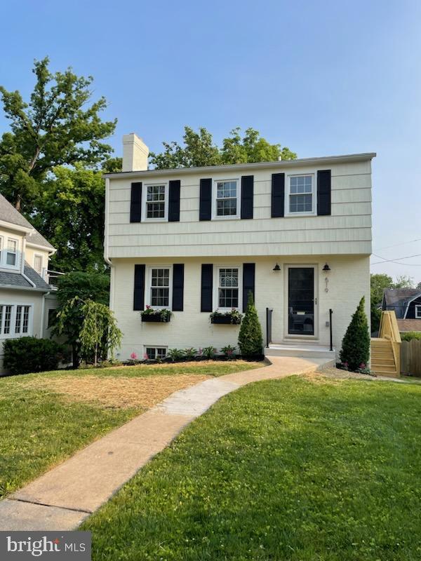 a view of house with yard and green space