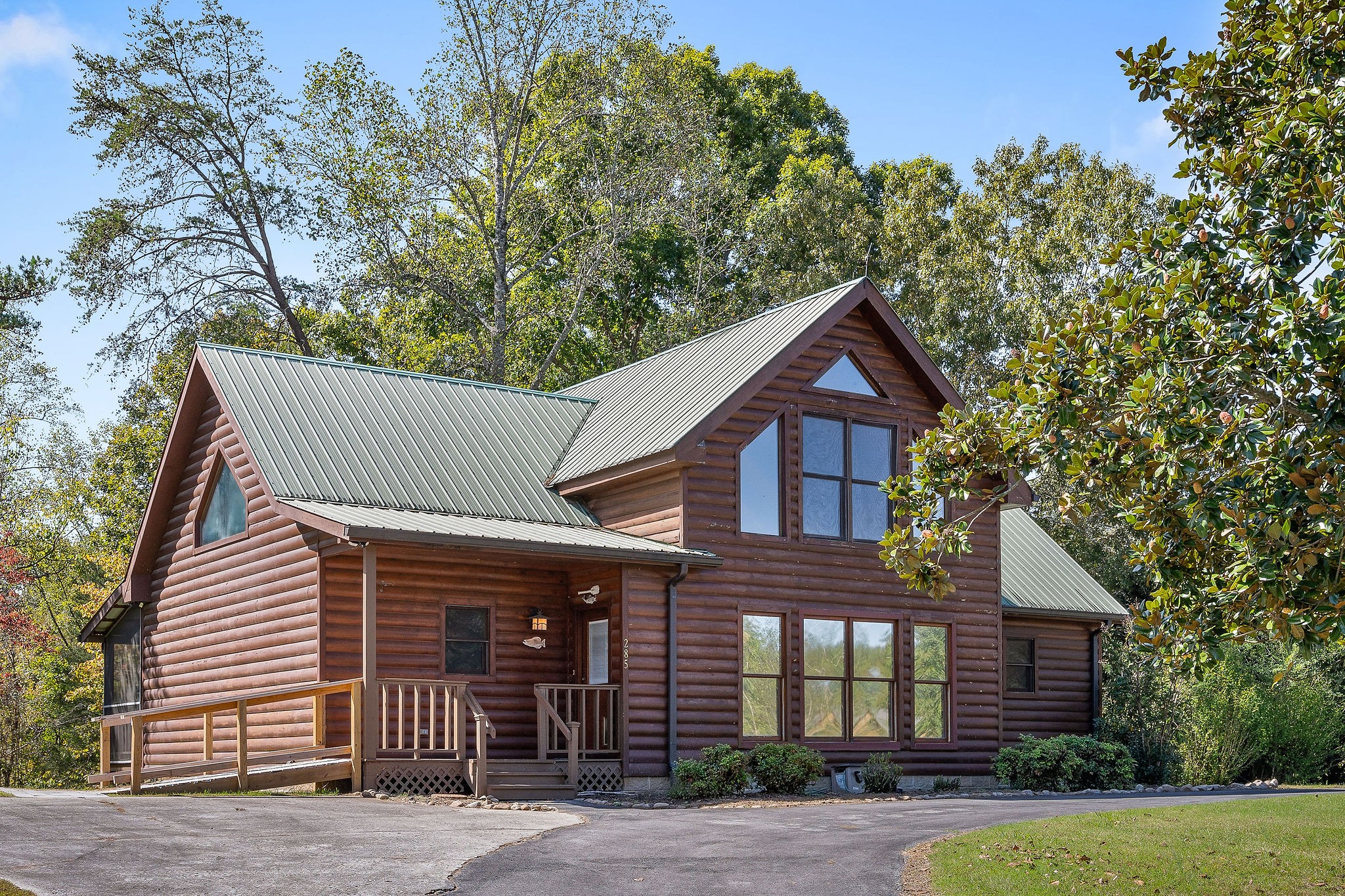 a front view of a house with a garden