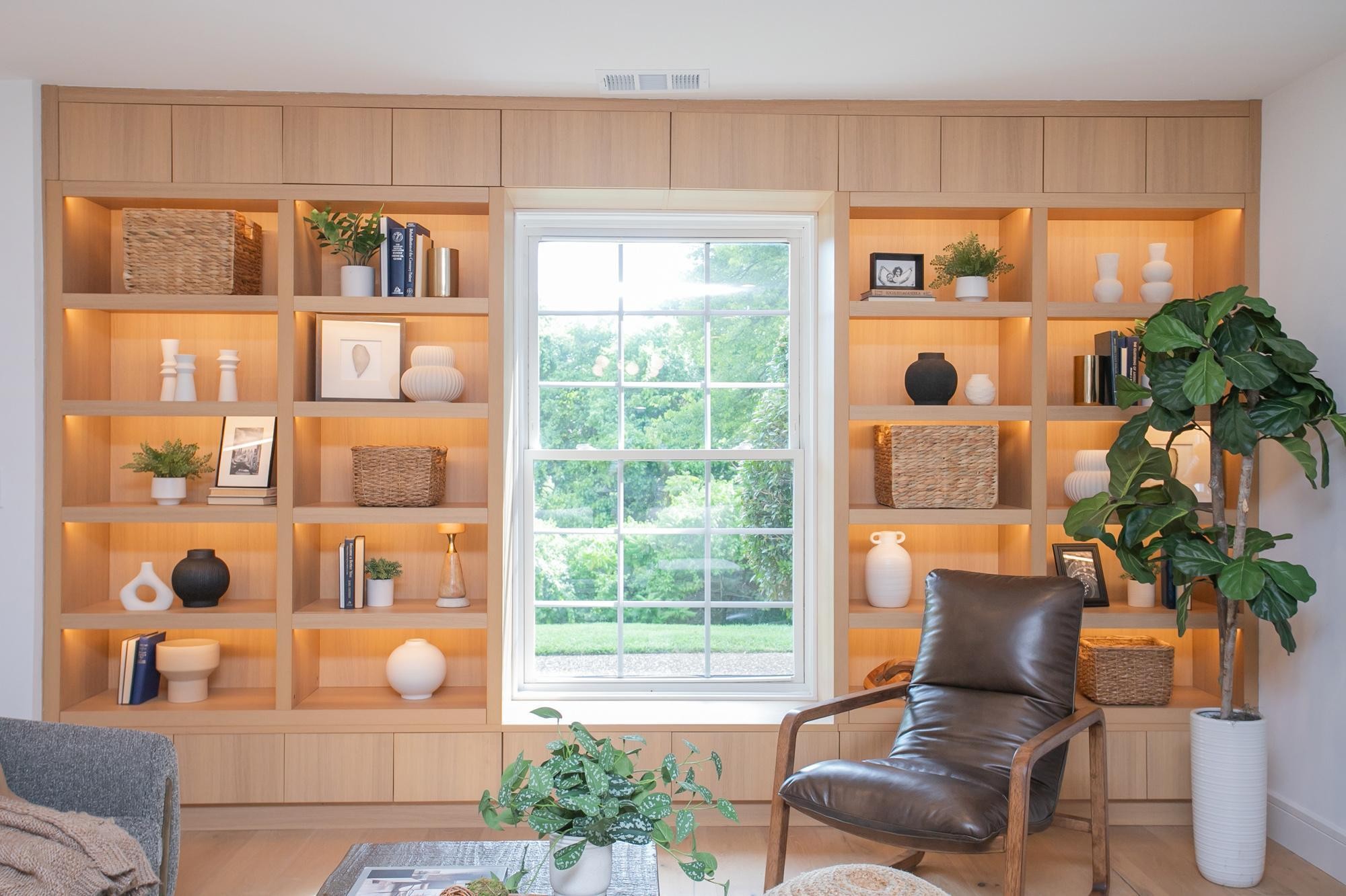 a living room with furniture and a potted plant