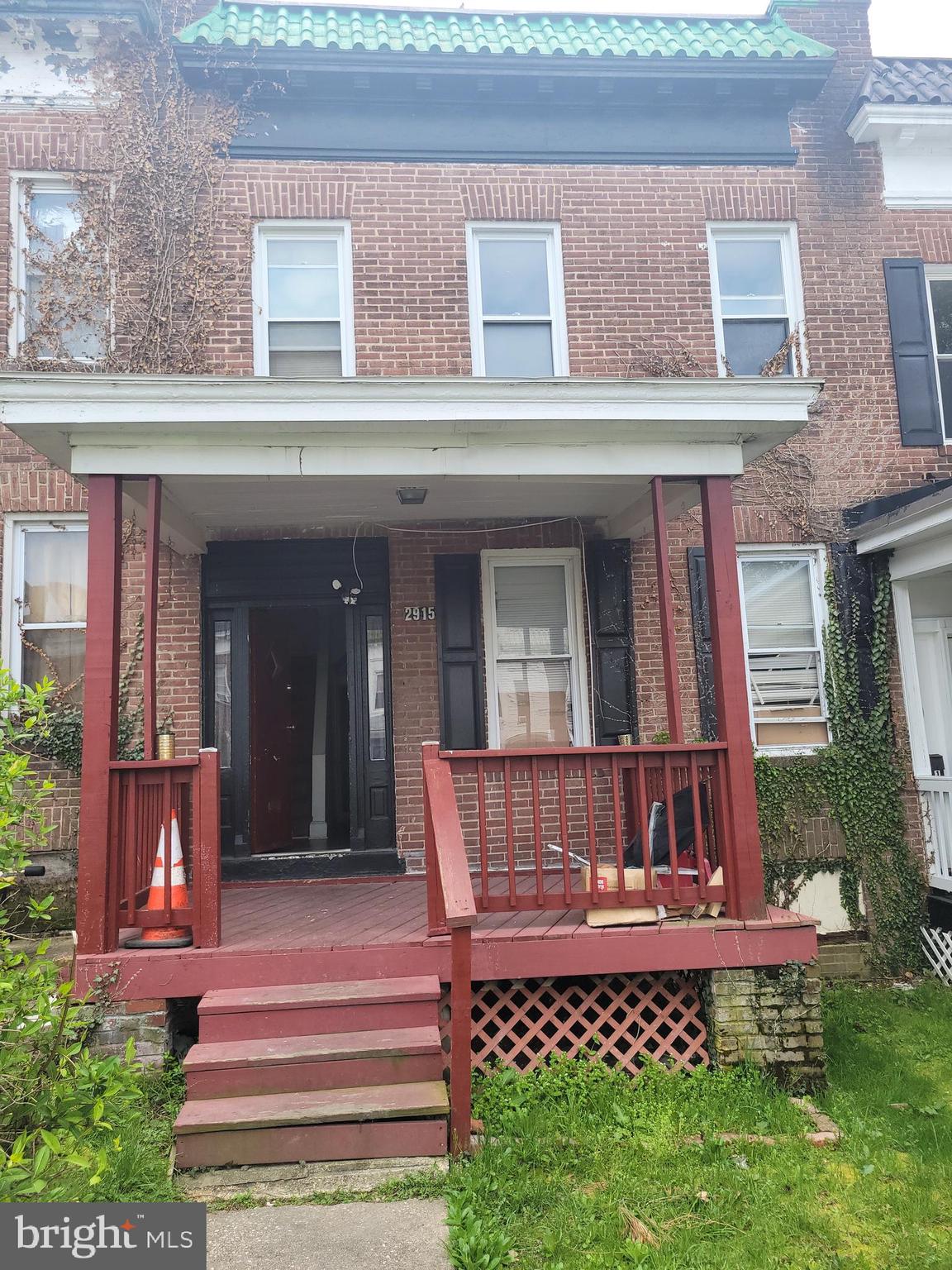 a view of a brick building with a bench in front of house