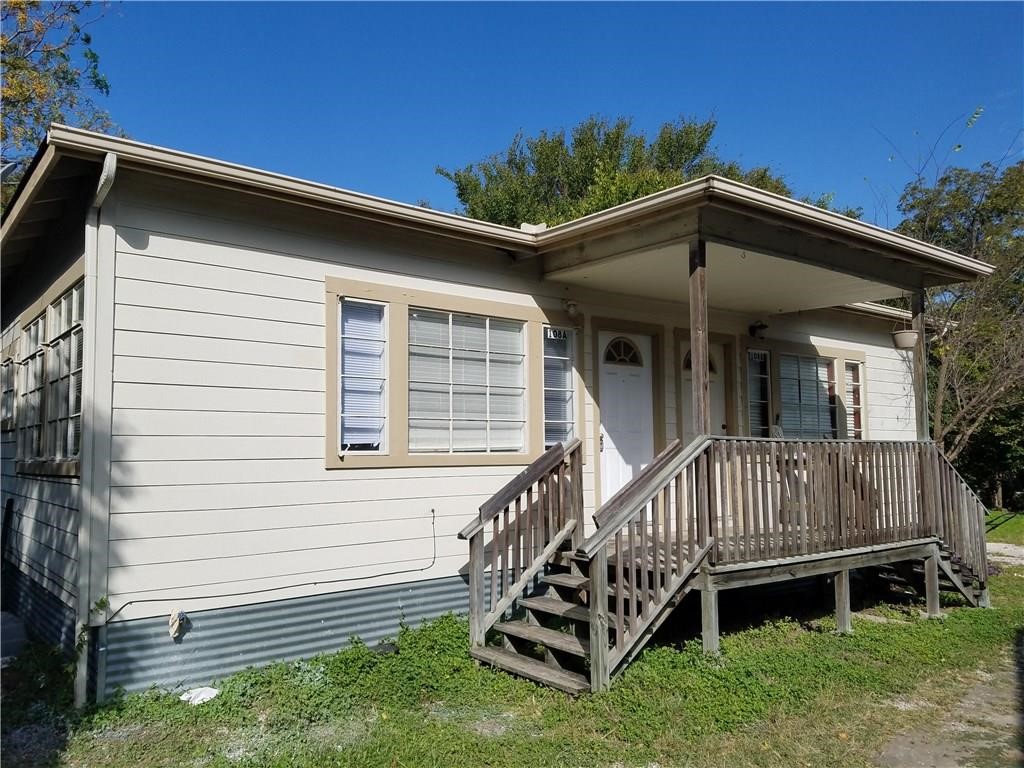 a view of a house with a yard deck and a garden