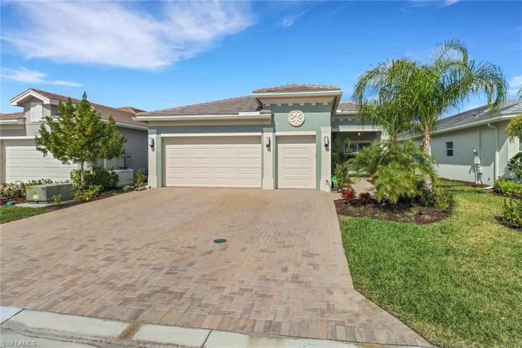 a front view of a house with a yard and a garage