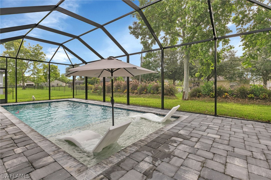 a view of a backyard with a swimming pool