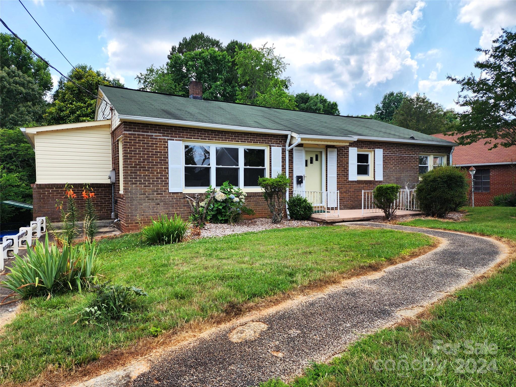 a front view of a house with garden