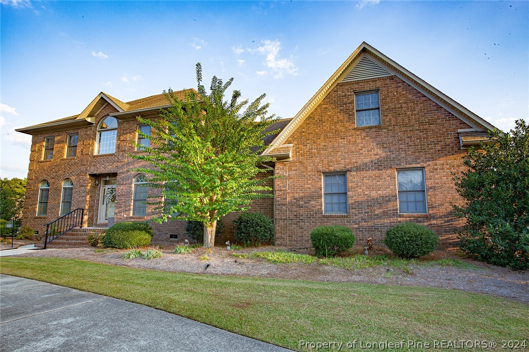 a front view of house with yard and green space