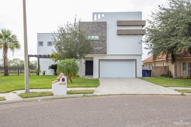 View of front of home featuring a front yard and a garage