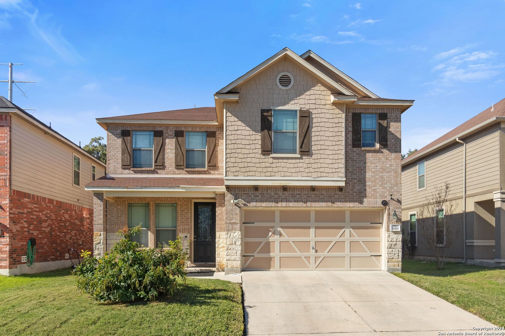 a front view of a house with a yard