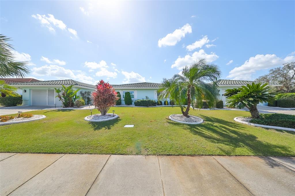 a view of a house with swimming pool and a yard