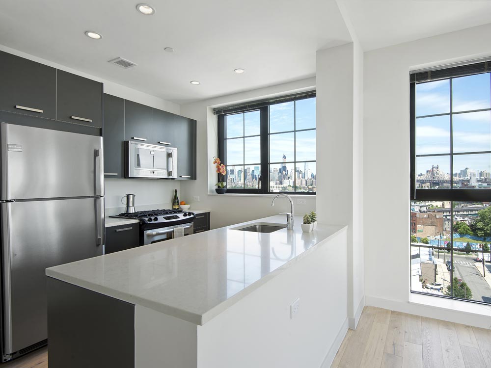 a kitchen with a refrigerator a stove and a window