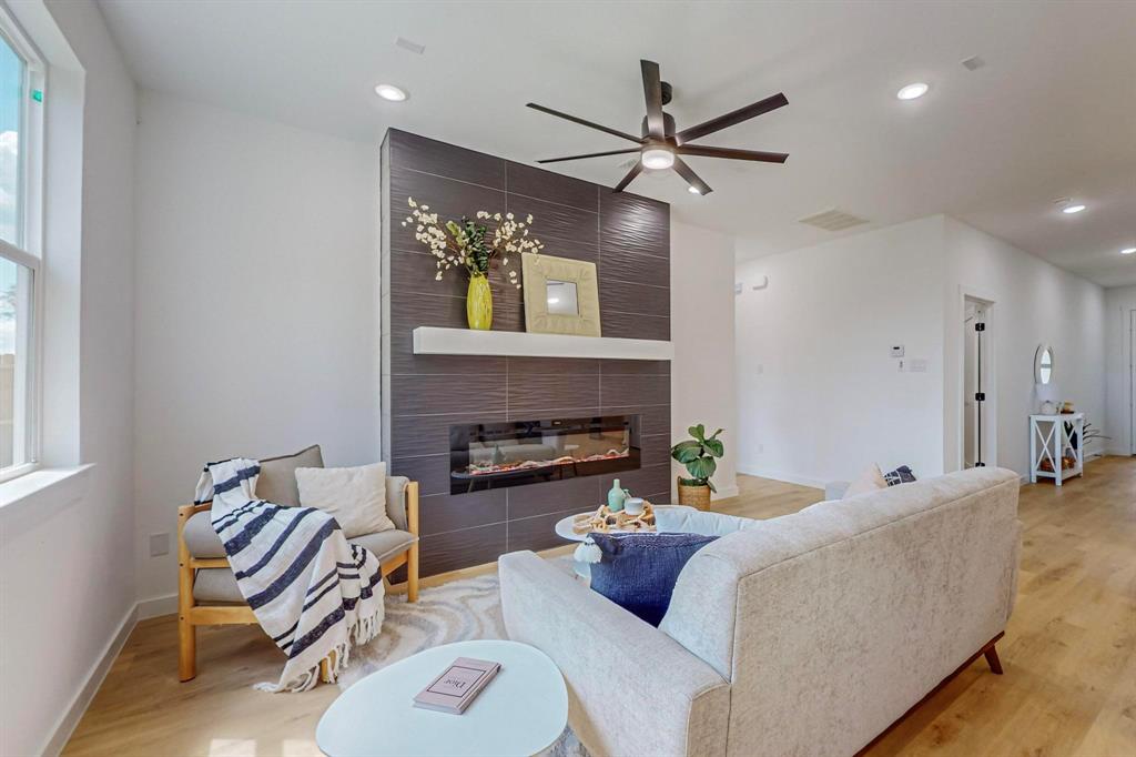 a living room with furniture and a wooden floor