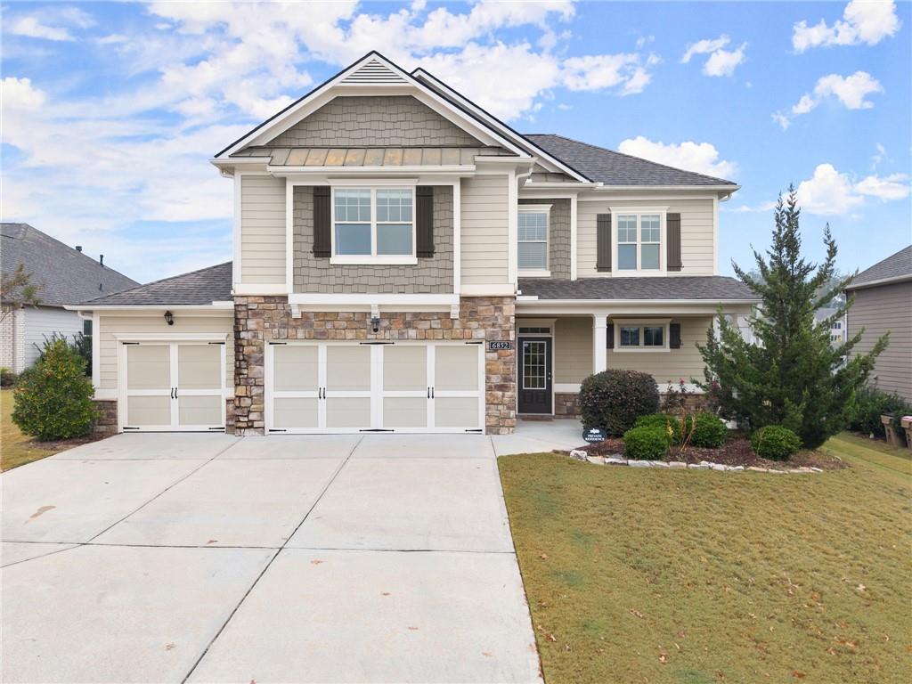 a front view of a house with a yard and garage