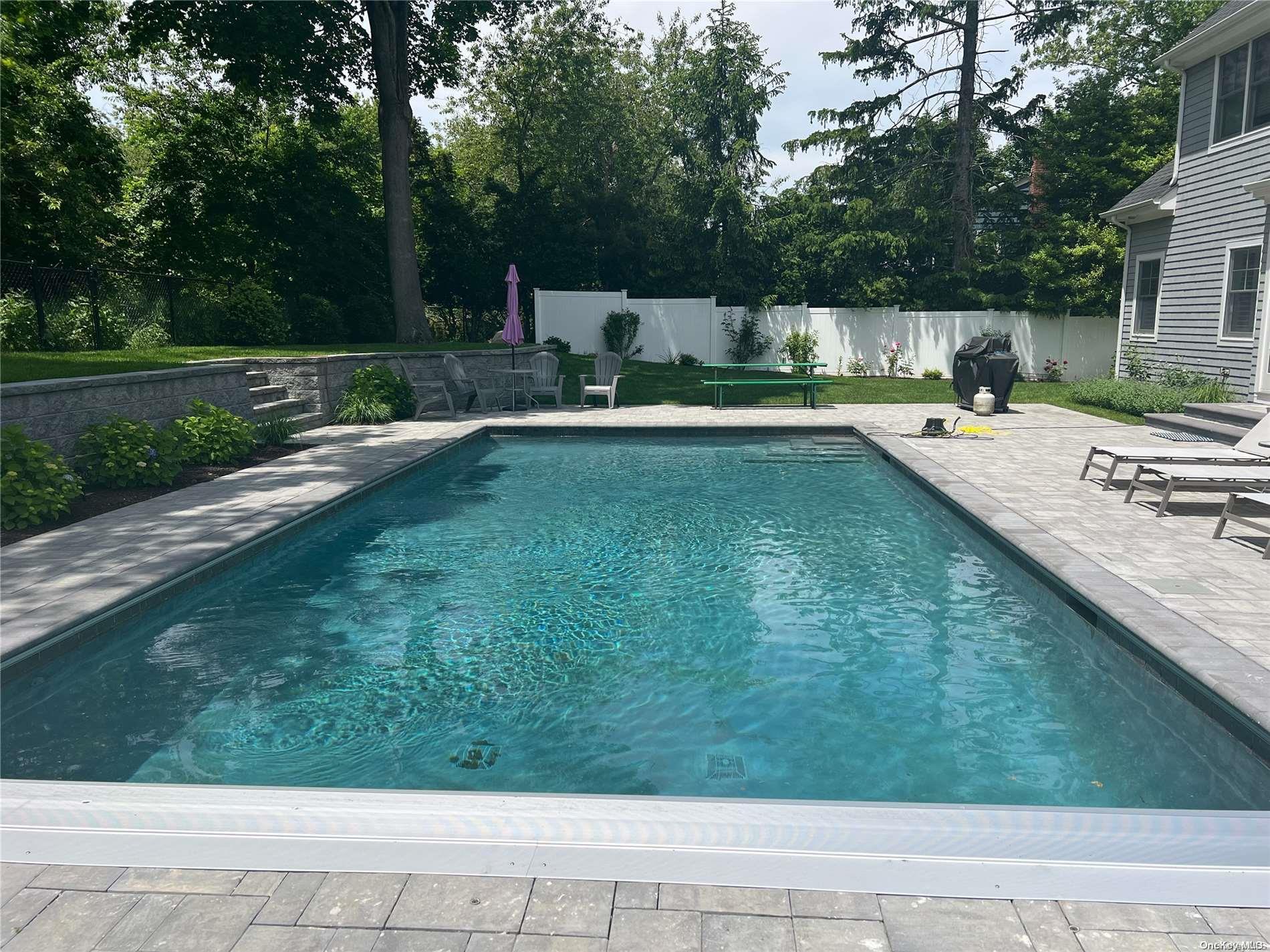 a view of a swimming pool with a patio