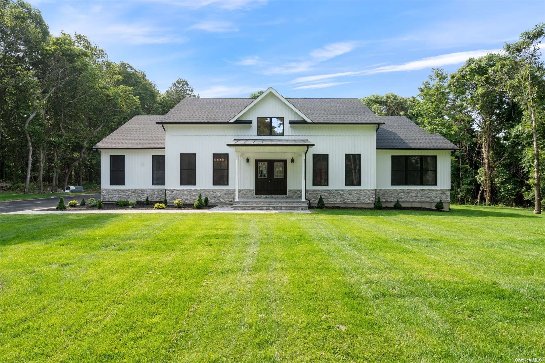 a front view of a house with a garden and porch