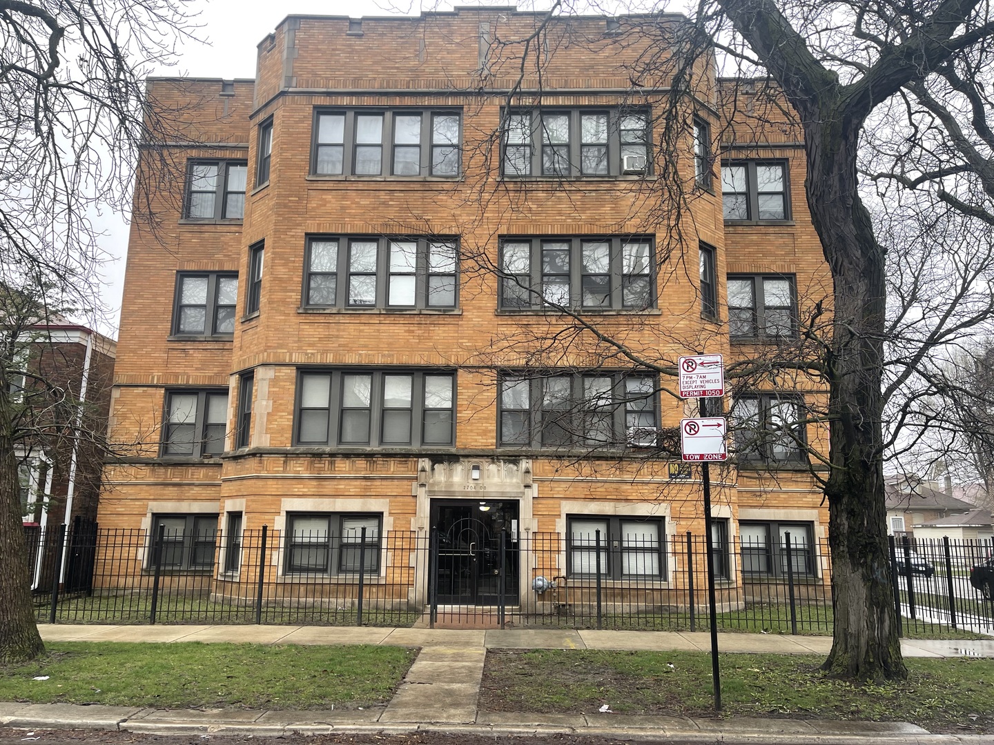 a front view of a residential apartment building with a yard