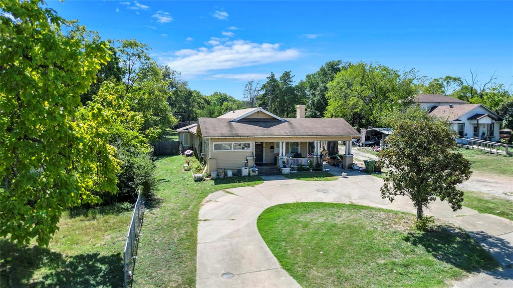 a front view of a house with yard patio and green space