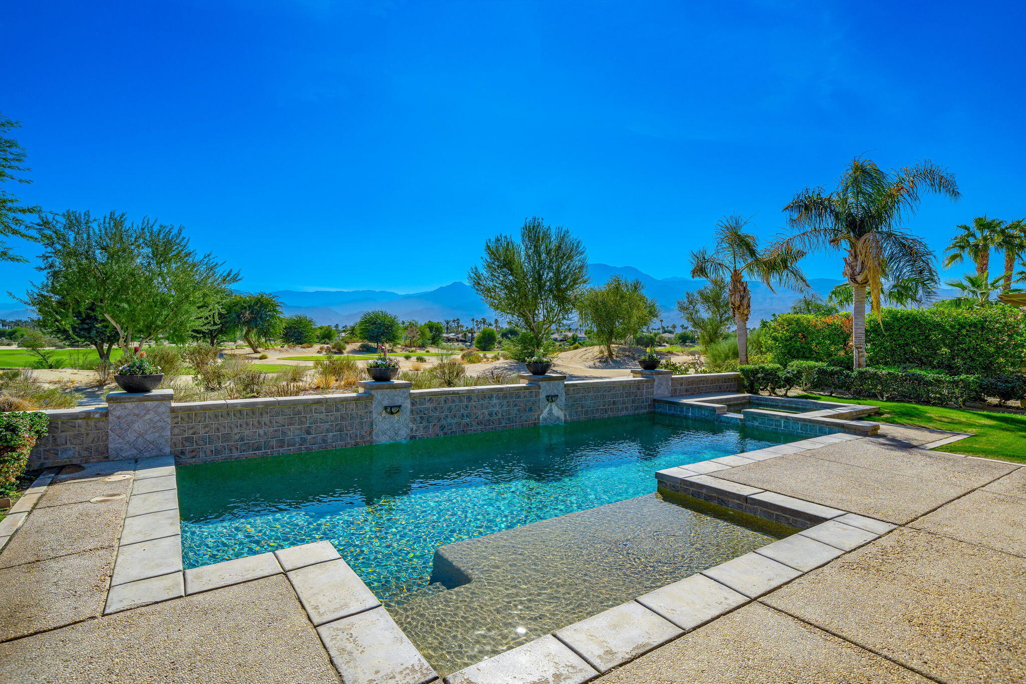 a view of swimming pool from a lounge chair