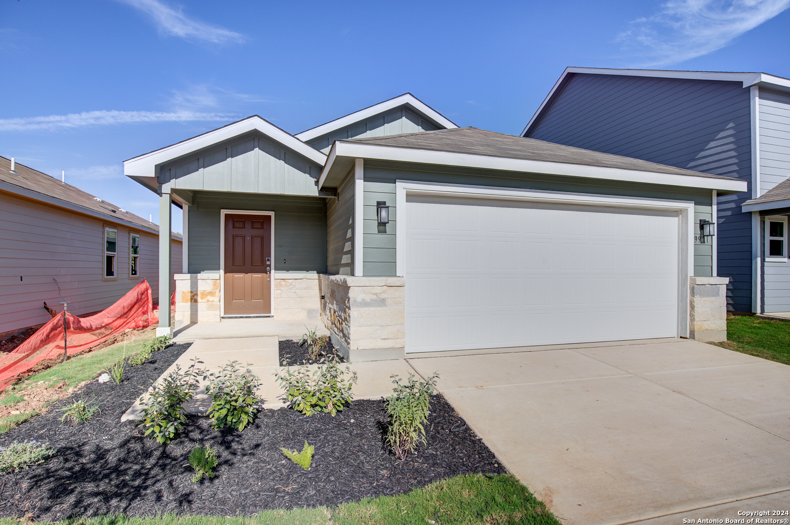 a front view of a house with garden