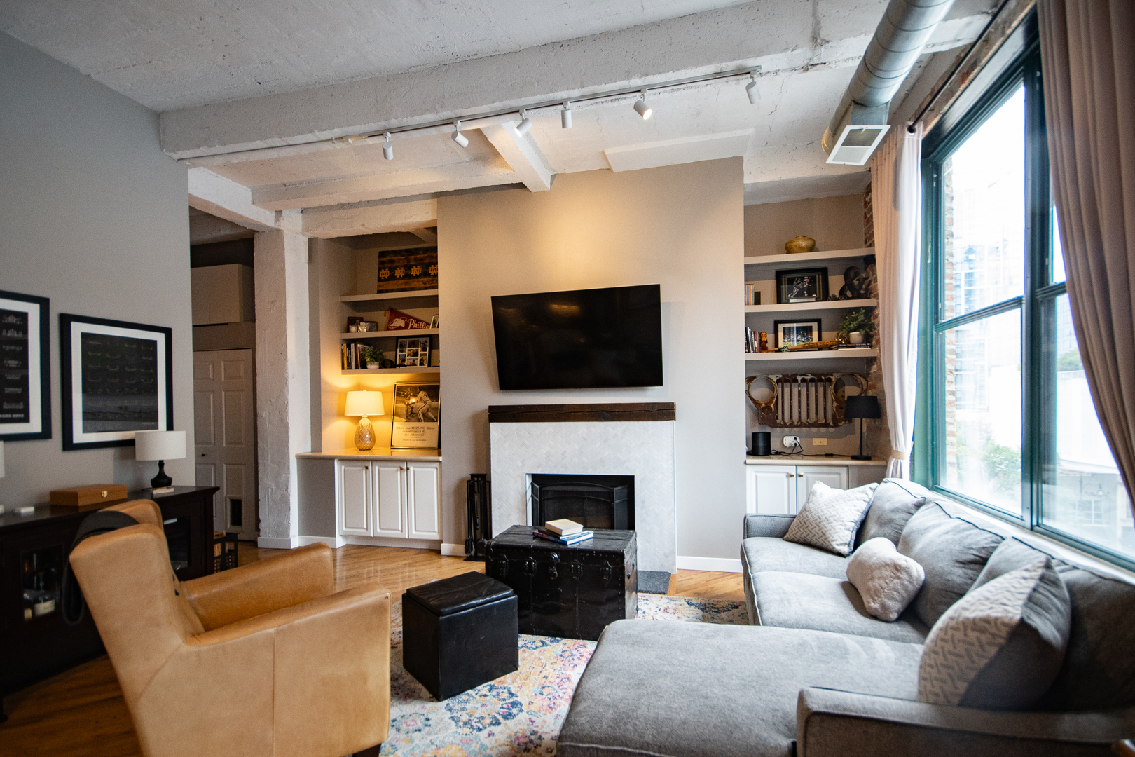 a living room with furniture fireplace and window