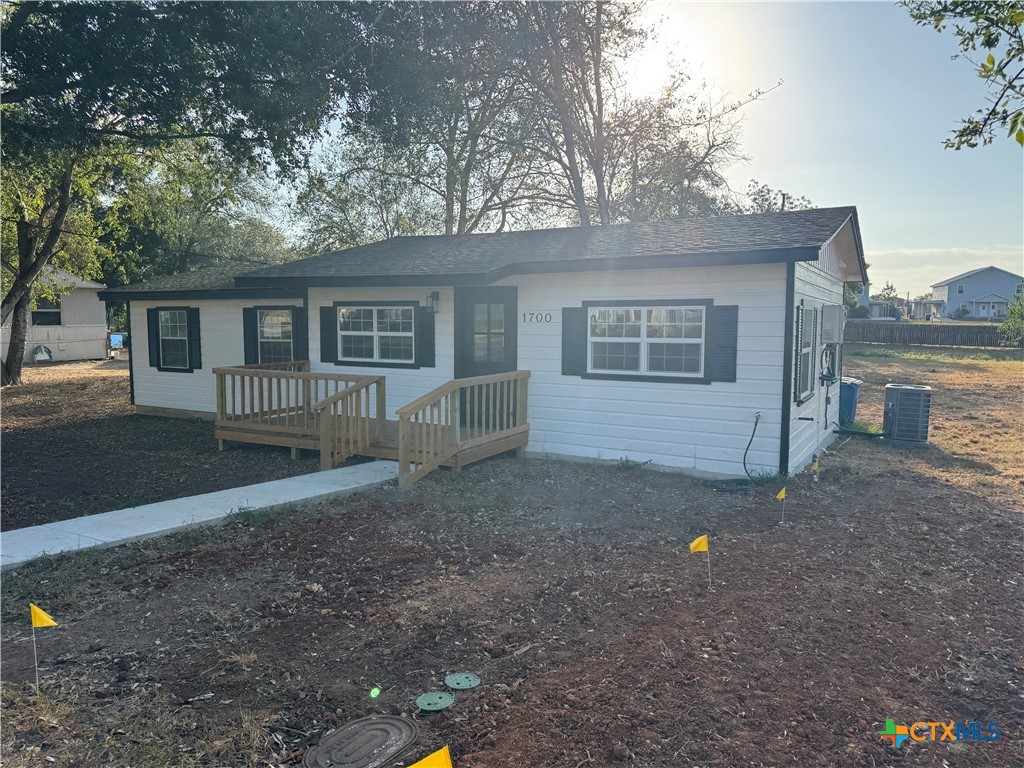 a backyard of a house with shaded area