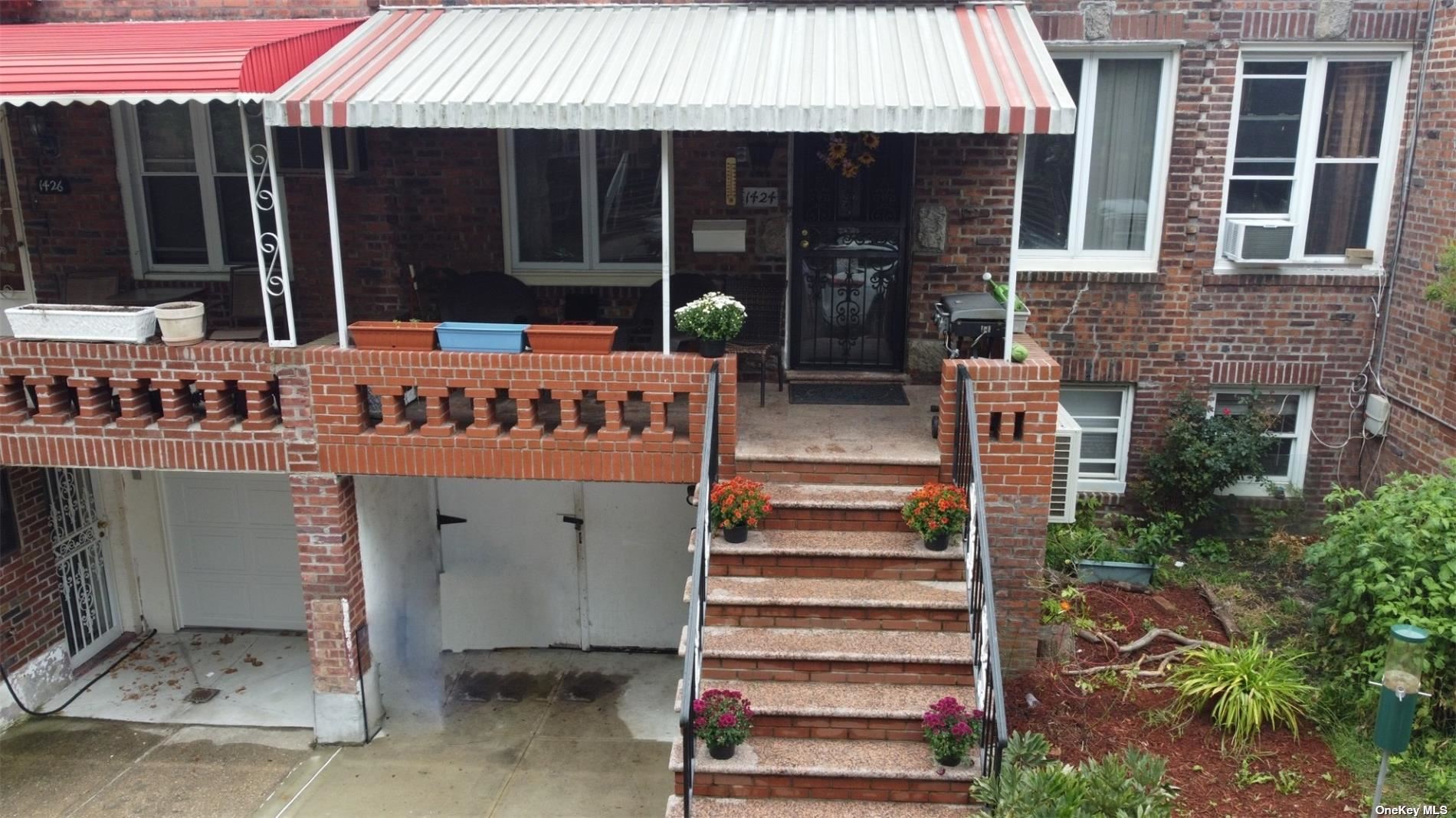 a front view of a house with glass windows and door