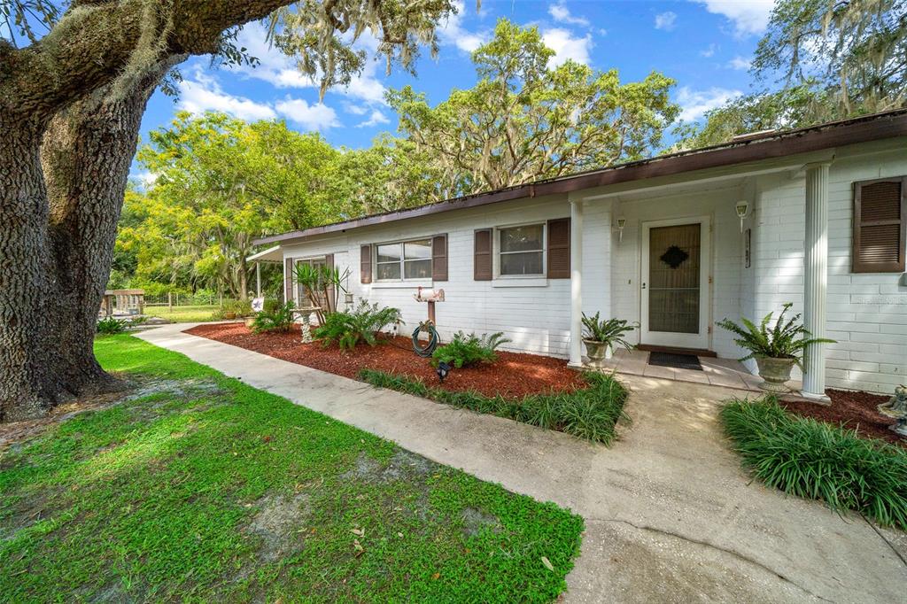 a front view of house with yard and green space