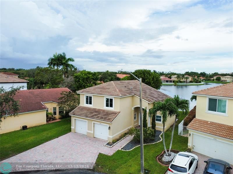 a aerial view of a house with roof deck and fireplace in the back