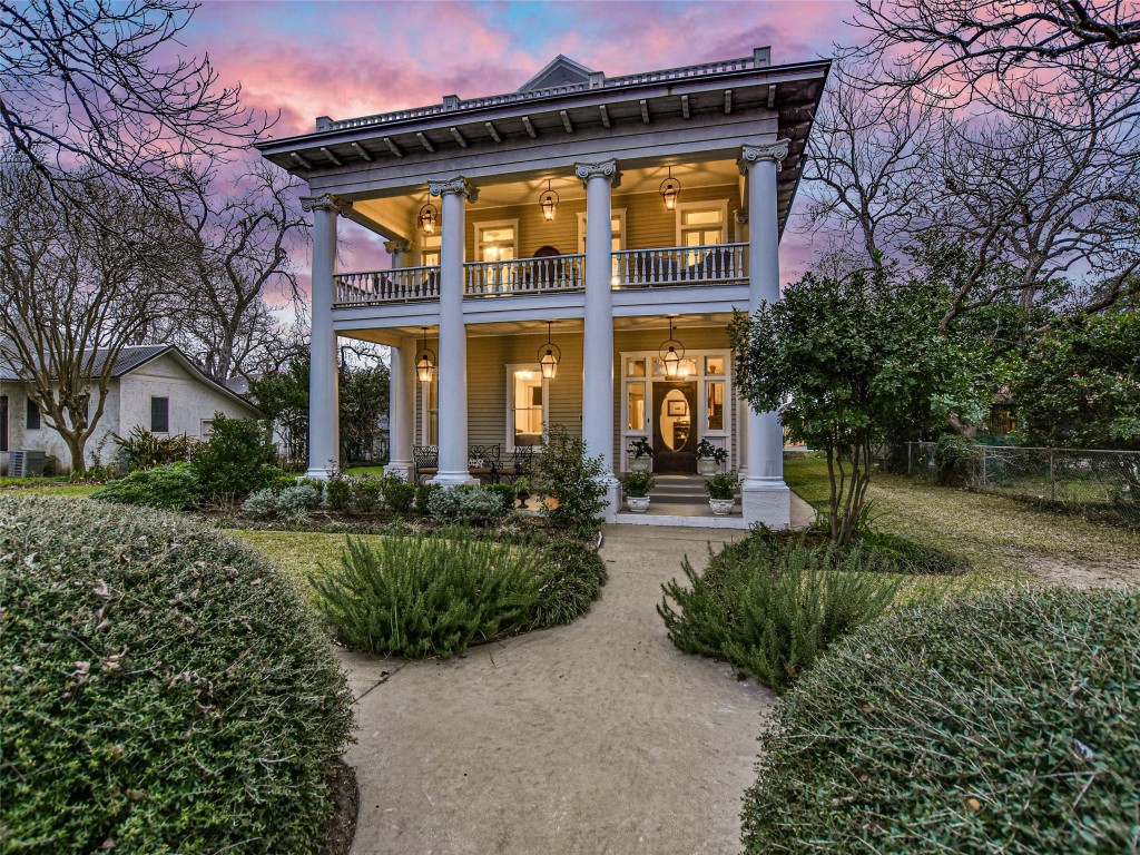 a front view of a house with garden