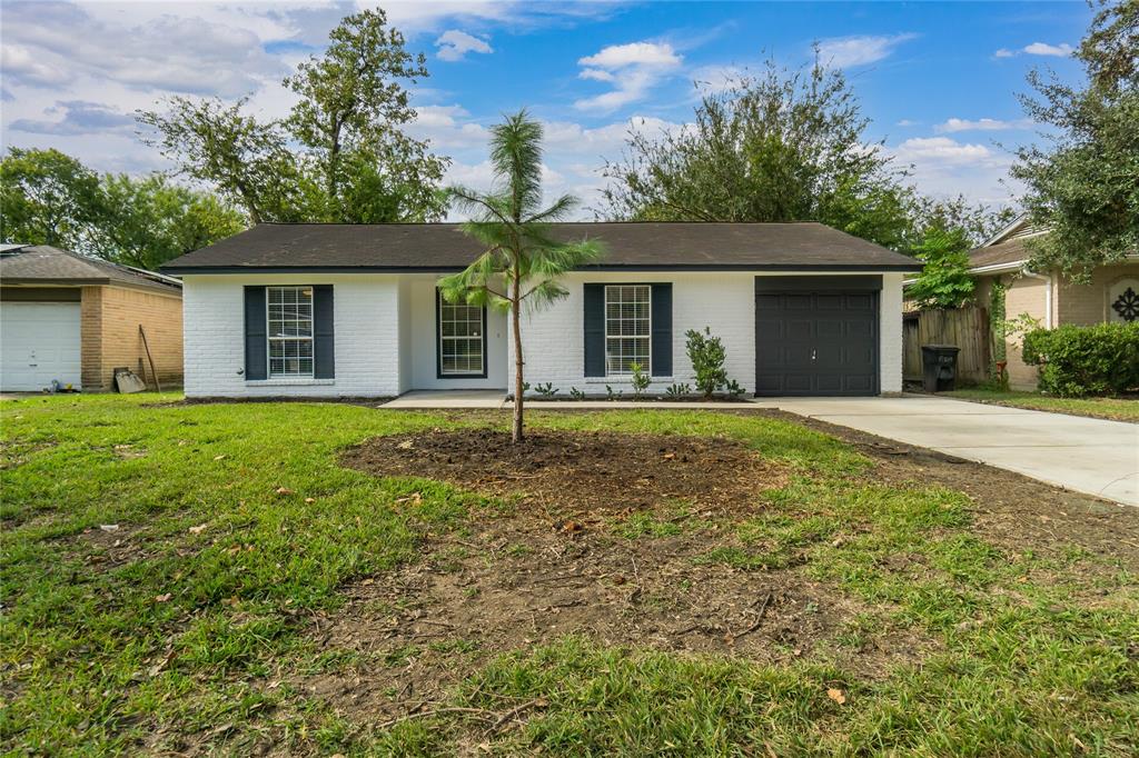 a front view of a house with yard and green space