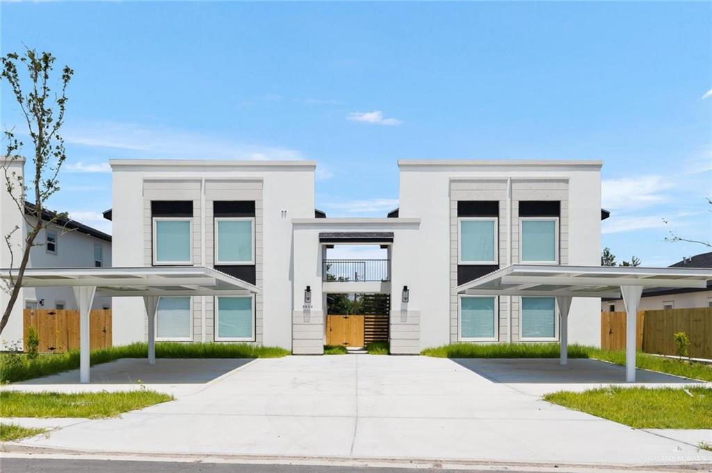 a view of a white building with a swimming pool