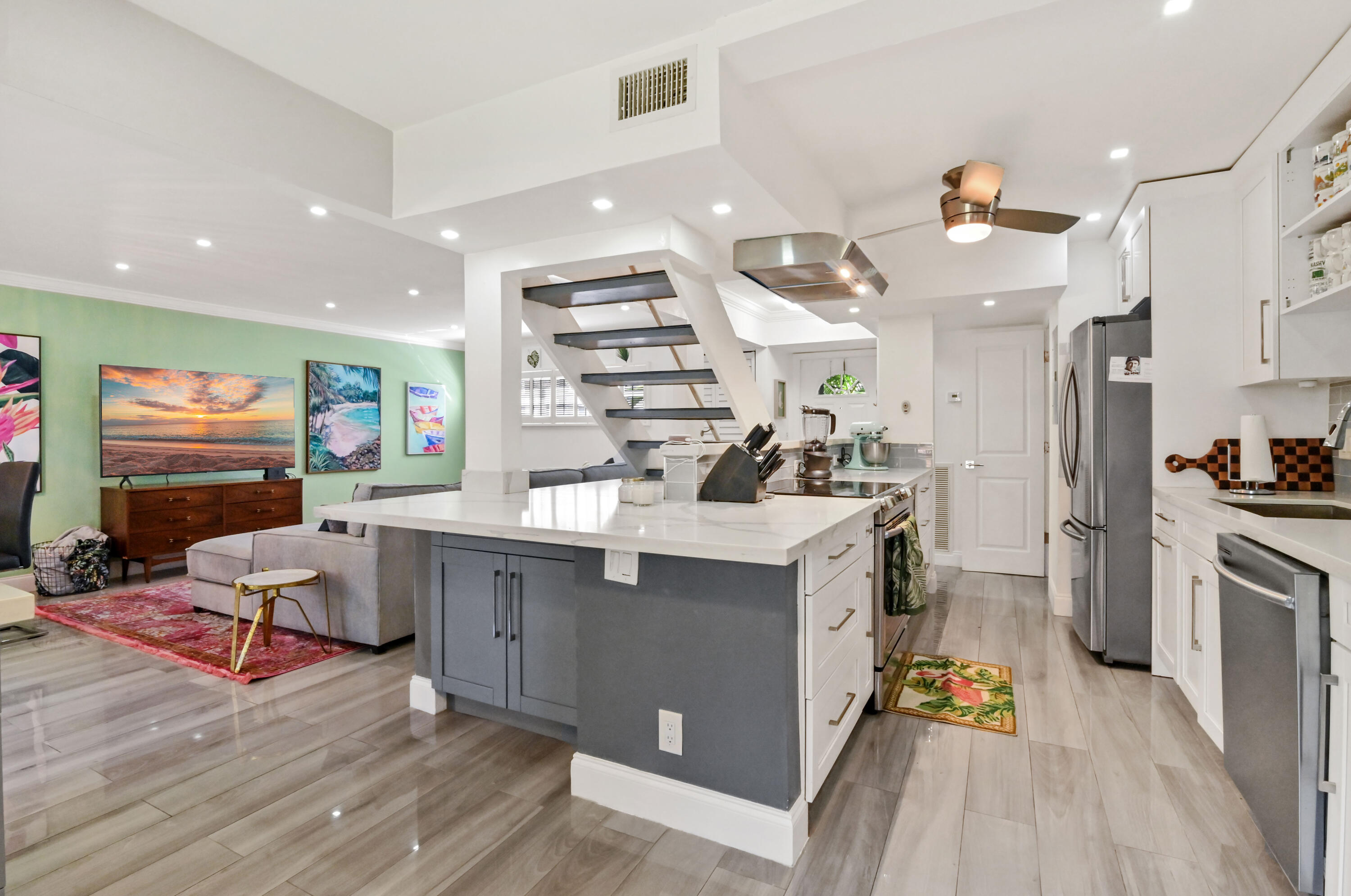 a kitchen with cabinets and wooden floor