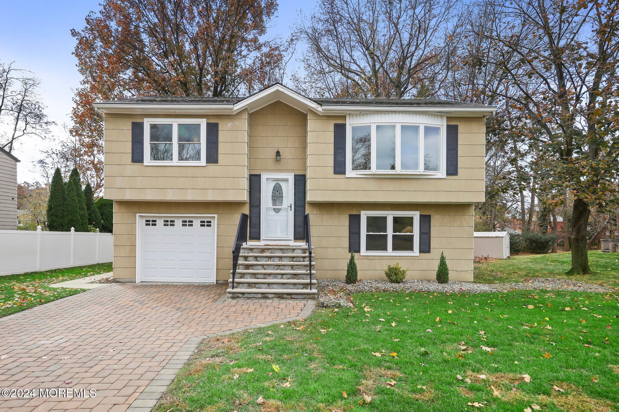 a front view of a house with a garden and yard