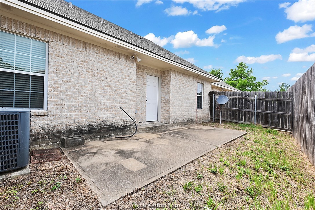 a view of backyard with wooden fence