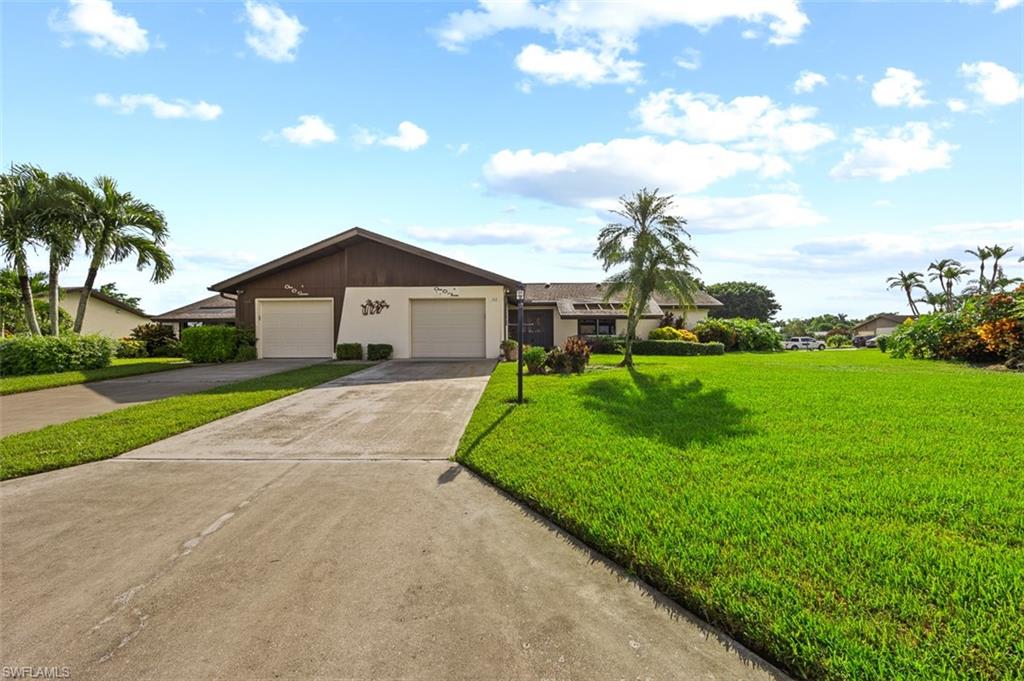 a front view of a house with a yard and garage