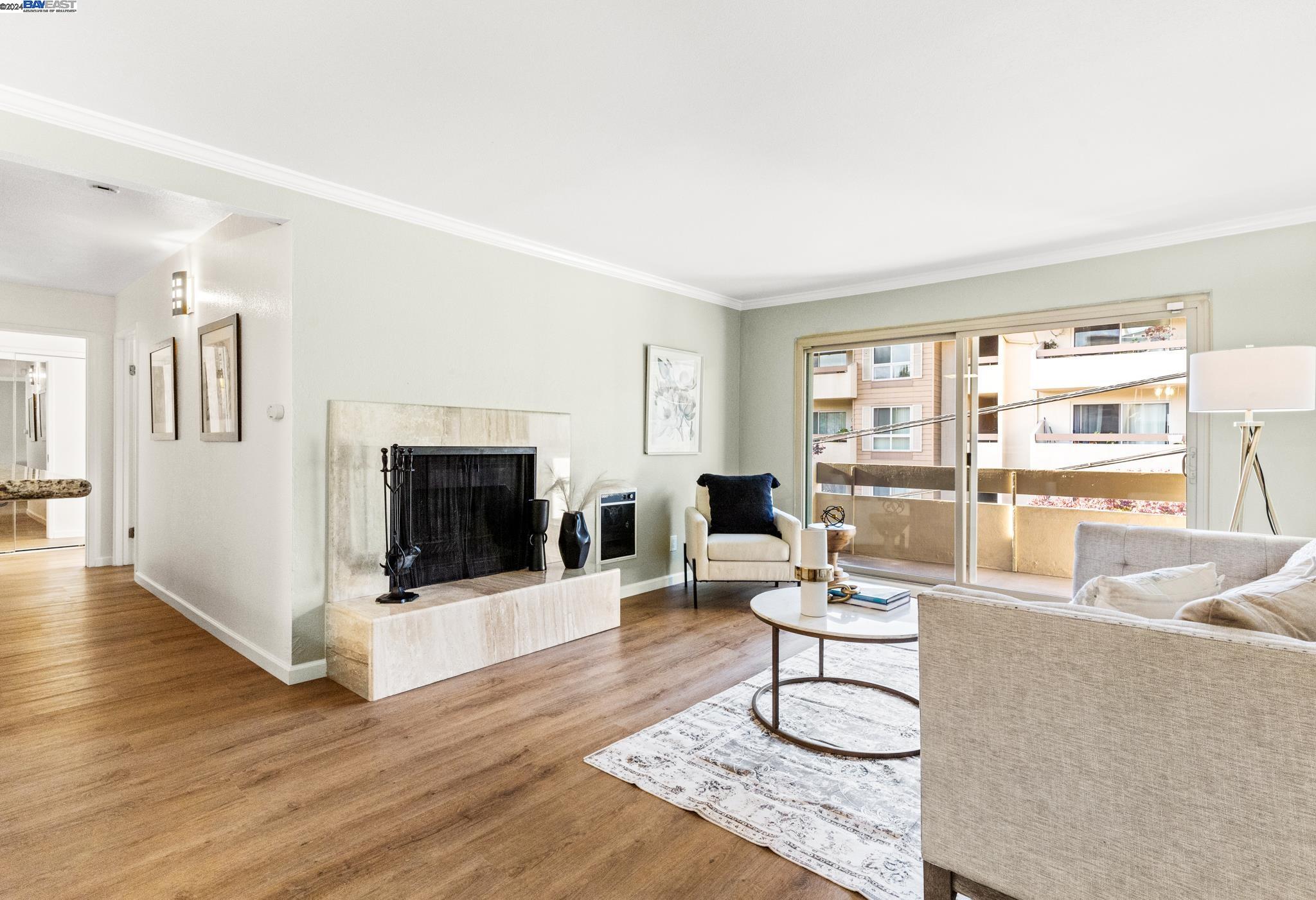 a living room with furniture a flat screen tv and a floor to ceiling window