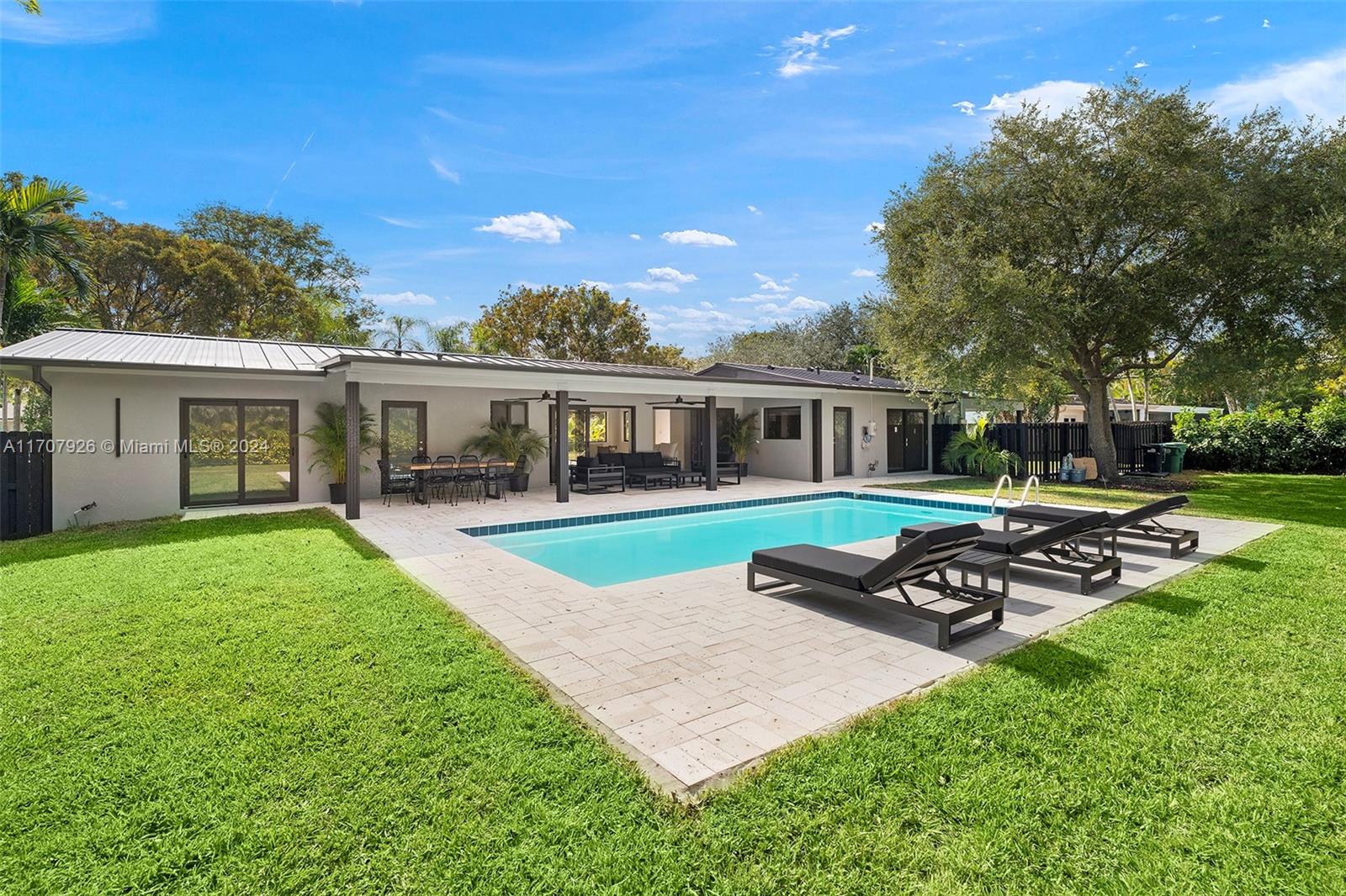 a front view of house with yard and outdoor seating