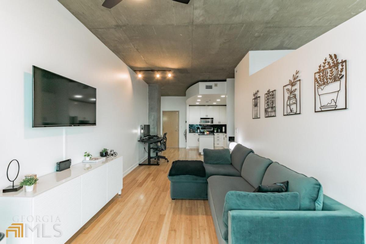 a living room with furniture and a flat screen tv