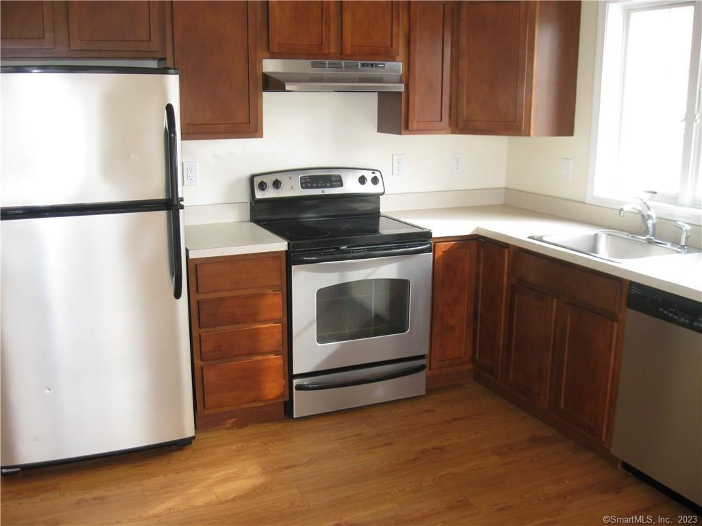 a kitchen with stainless steel appliances granite countertop a stove a microwave and a refrigerator