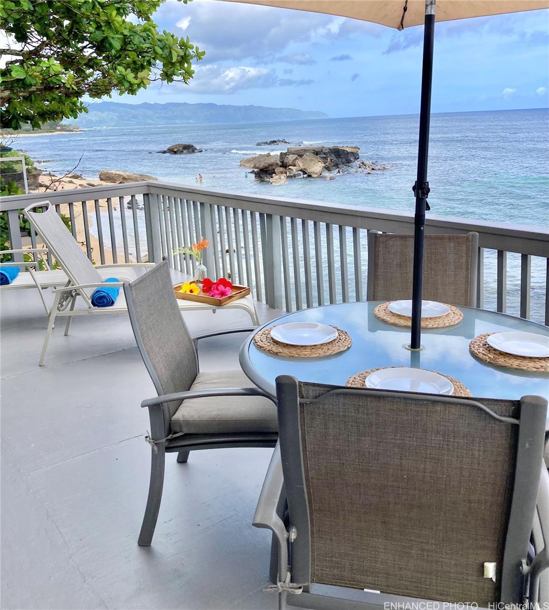 a outdoor dining space with furniture and wooden floor