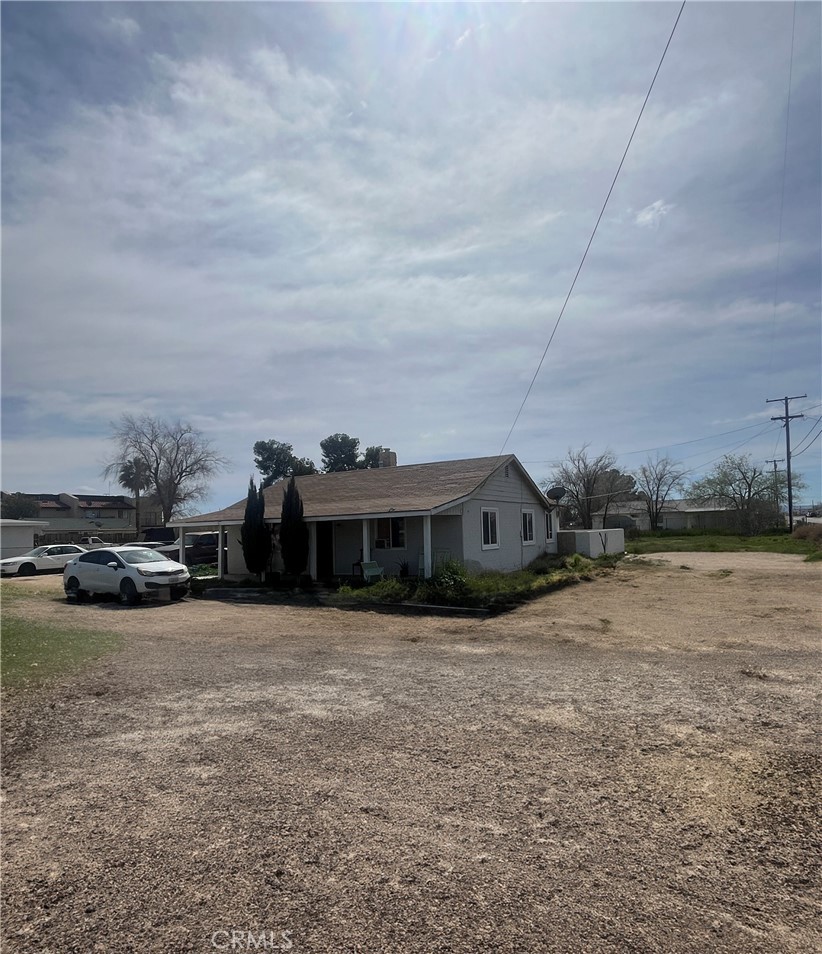 a view of a house with yard and sitting area