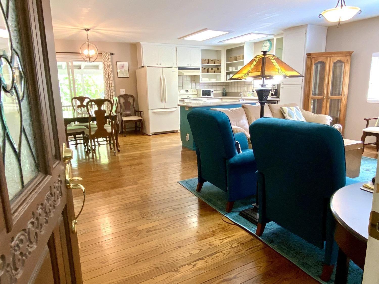 a living room with furniture dining area and a large window