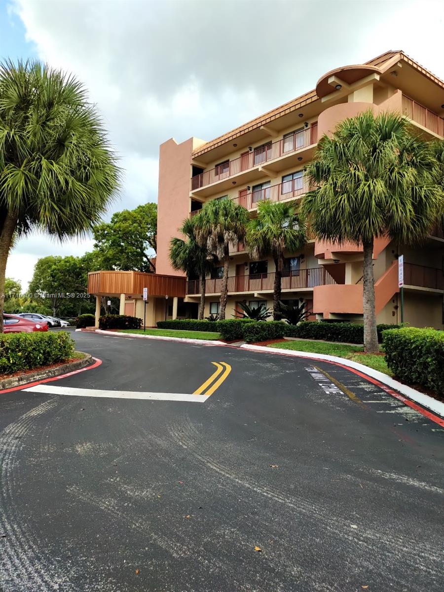 a front view of a building with trees