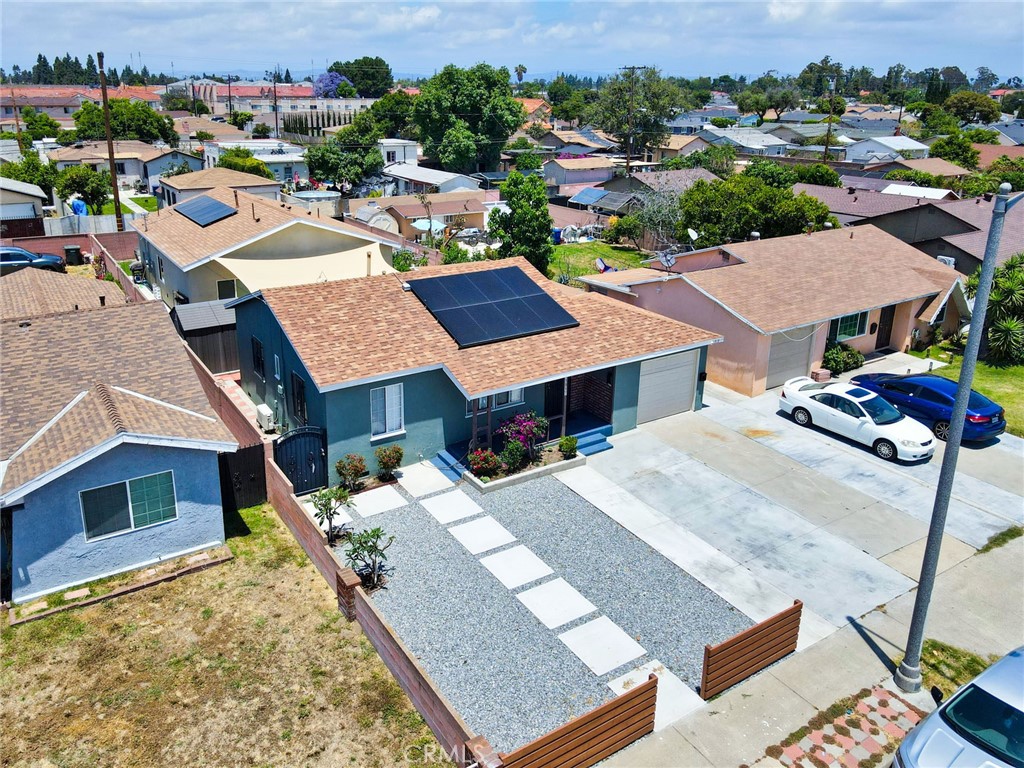 an aerial view of multiple houses with a yard