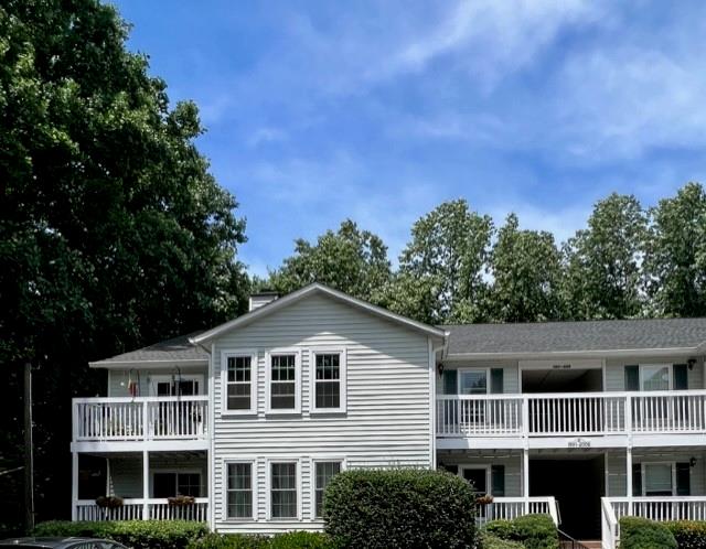 a front view of a house with a yard and trees